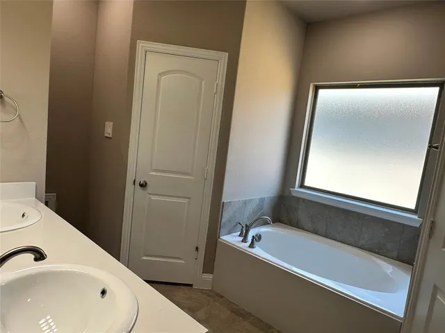 a bathroom with a shower and a sink