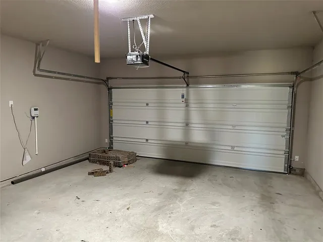 a kitchen with stainless steel appliances granite countertop a refrigerator a sink dishwasher a dining table and chairs with wooden floor