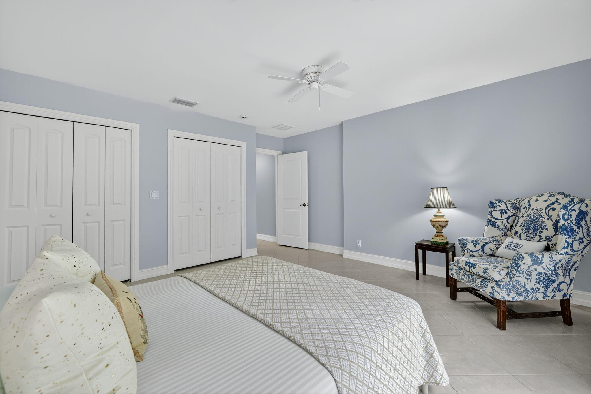 4 Rio Vista Drive Sewall's Point, FL 34996 - Photo 13 of 19 a bedroom with a bed and a chandelier
