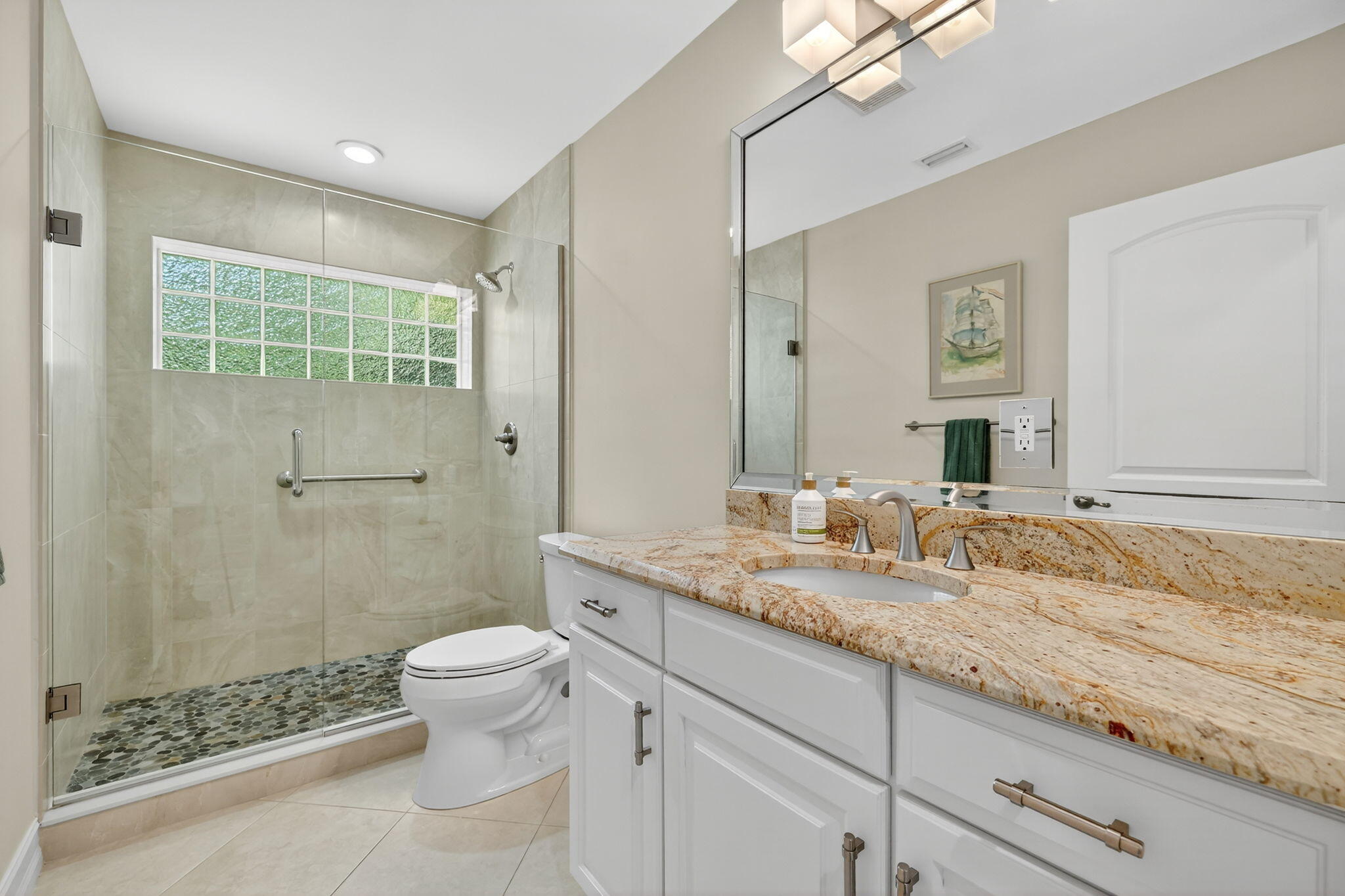 4 Rio Vista Drive Sewall's Point, FL 34996 - Photo 14 of 19 a bathroom with a granite countertop sink a toilet and shower
