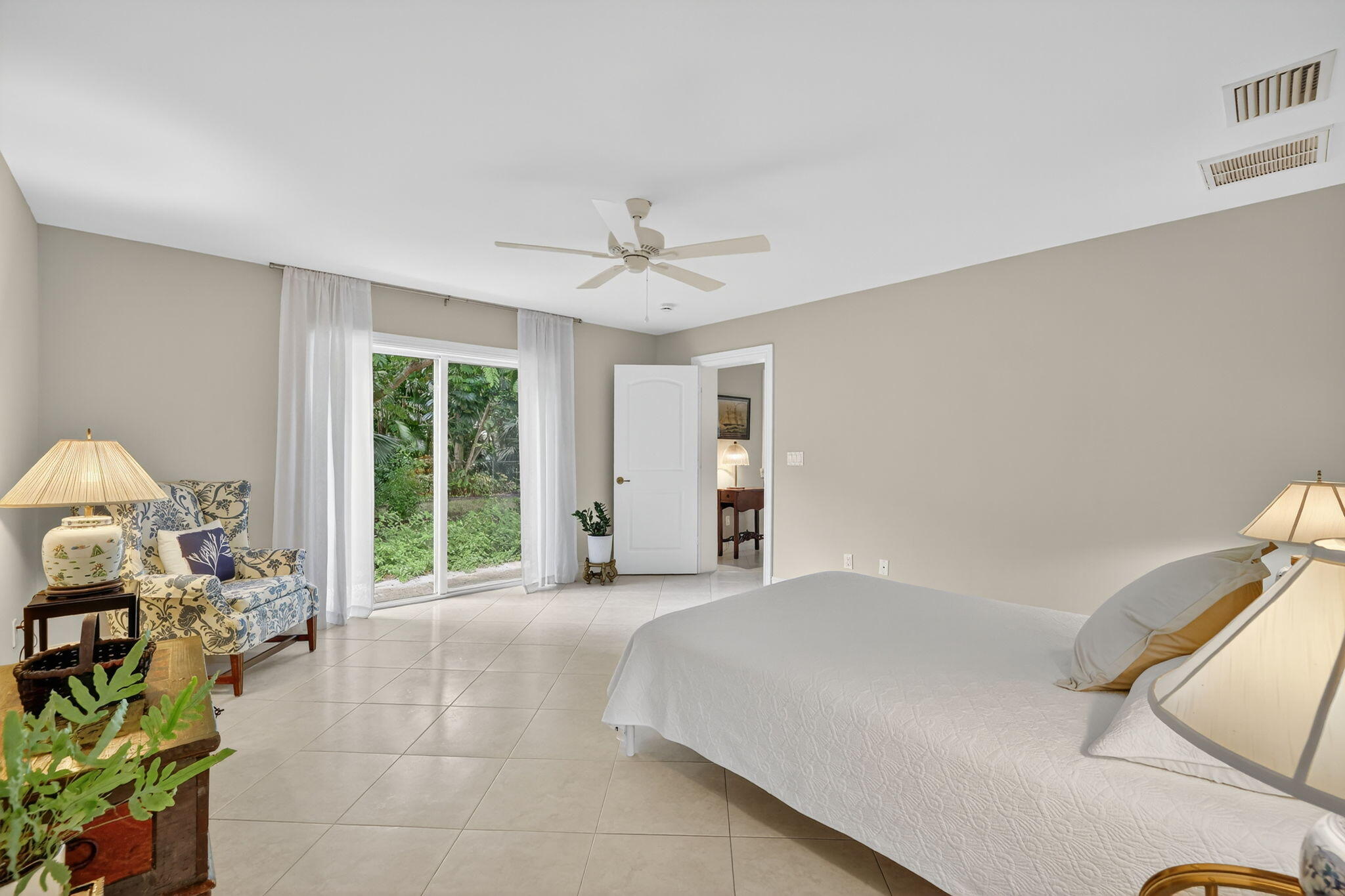 4 Rio Vista Drive Sewall's Point, FL 34996 - Photo 9 of 19 a spacious bedroom with a bed a table and a large window