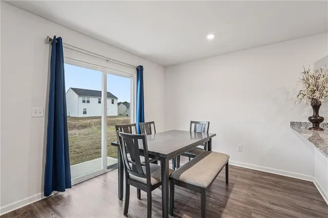 a dining room with furniture and wooden floor
