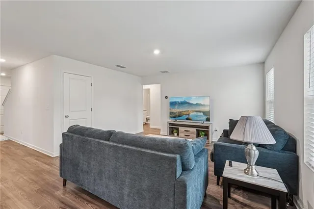 a living room with furniture a lamp and a window