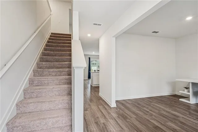 a view of an entryway with wooden floor