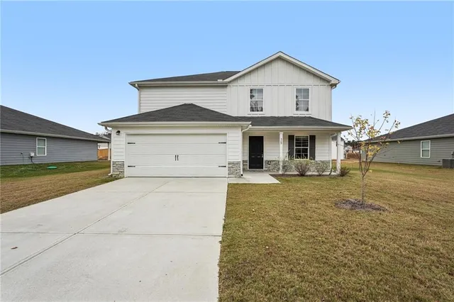 a front view of a house with a yard