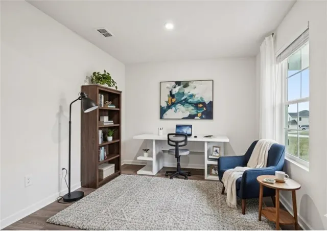 a living room with furniture a rug and a large window