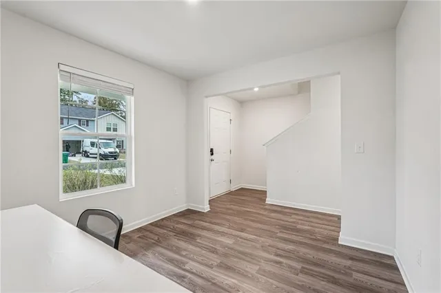 a view of a livingroom with wooden floor and a window