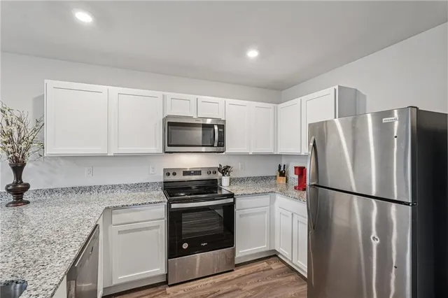 a kitchen with a refrigerator stove and microwave