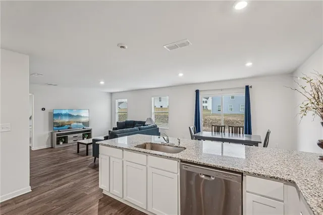 a kitchen with granite countertop a sink and cabinets