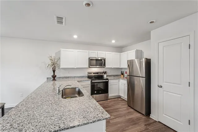 a kitchen with a refrigerator sink and stainless steel appliances