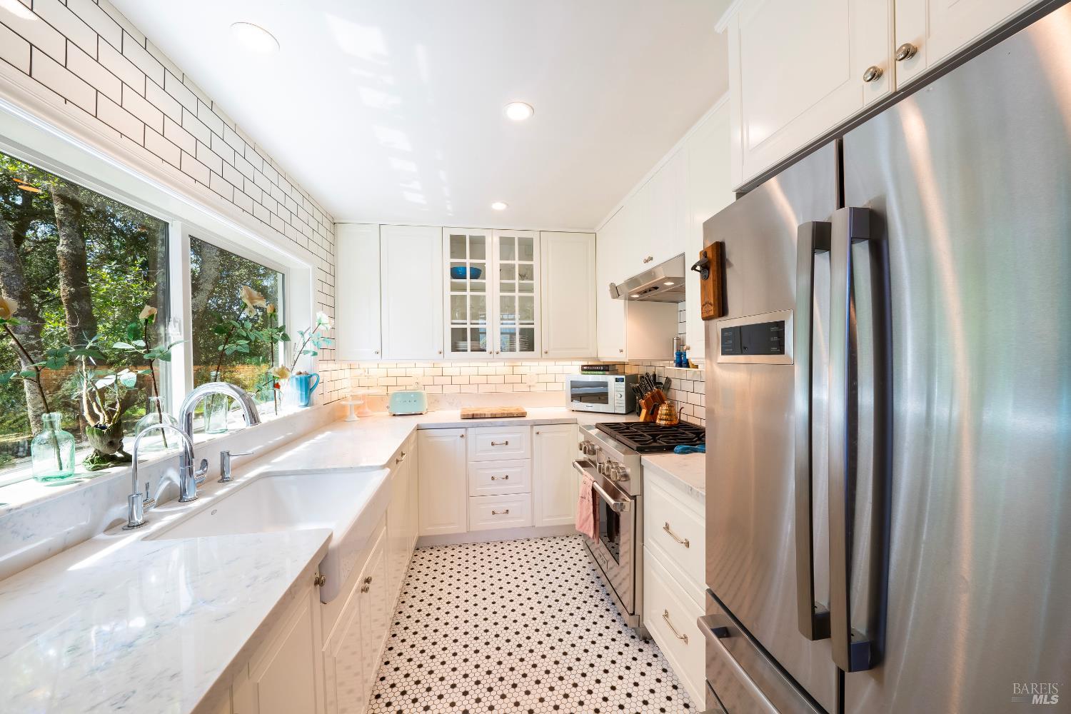 5270 Dry Creek Road Napa, CA 94558 - Photo 15 of 56 a kitchen with stainless steel appliances granite countertop a refrigerator a sink dishwasher a stove and white countertops with wooden floor