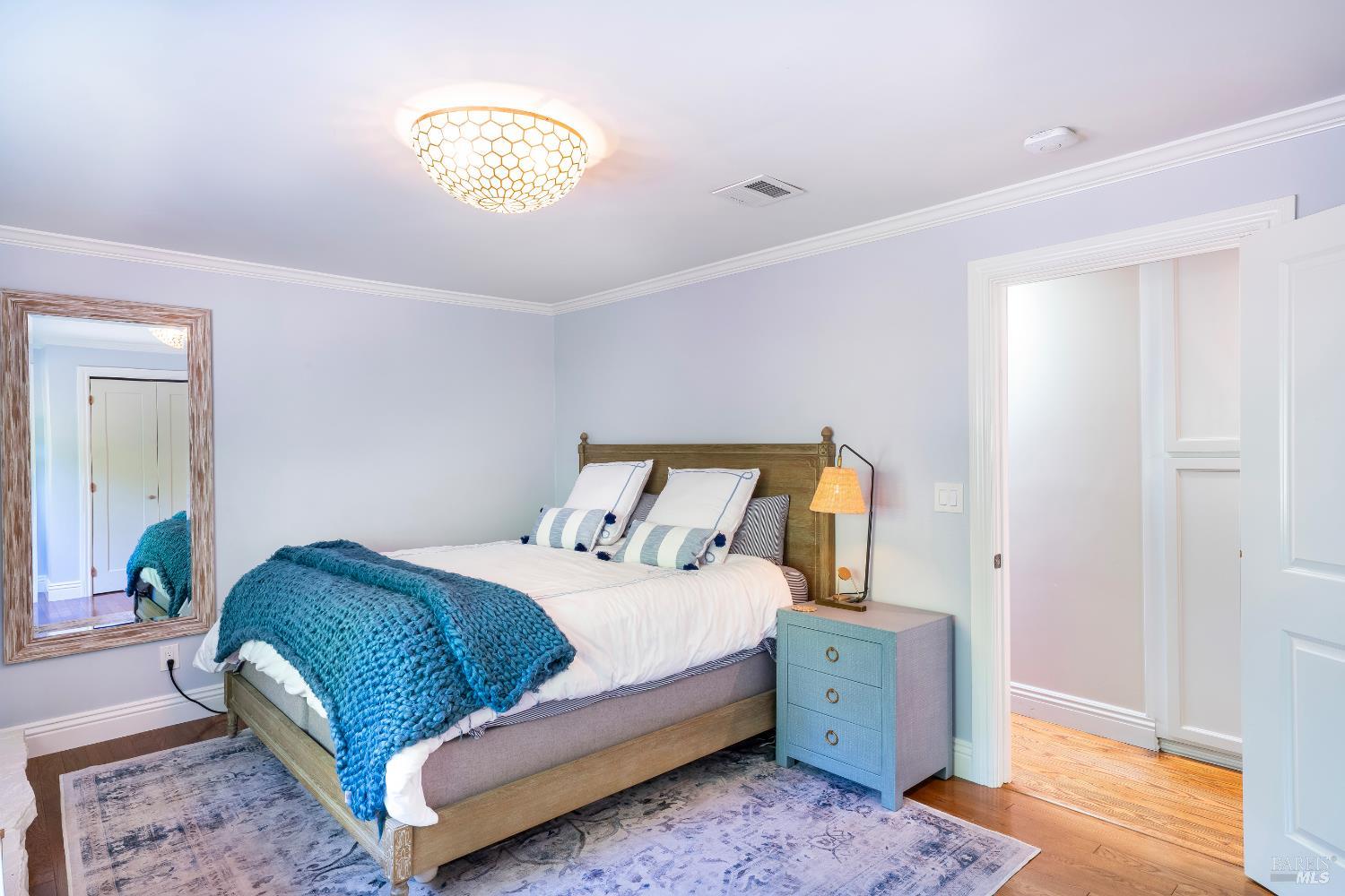 5270 Dry Creek Road Napa, CA 94558 - Photo 17 of 56 a bedroom with a bed and a lamp