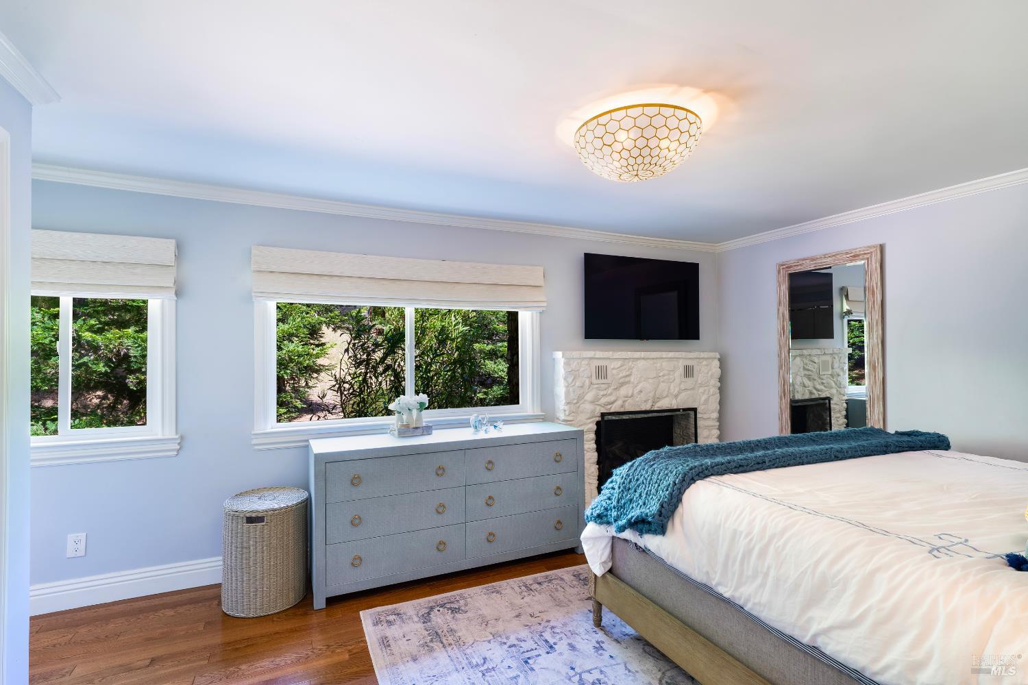 5270 Dry Creek Road Napa, CA 94558 - Photo 18 of 56 a bedroom with a bed and a chandelier