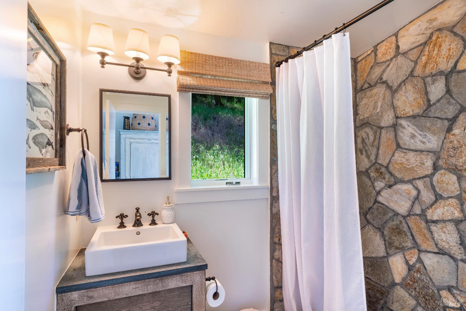 5270 Dry Creek Road Napa, CA 94558 - Photo 29 of 56 a bathroom with a sink vanity and a mirror