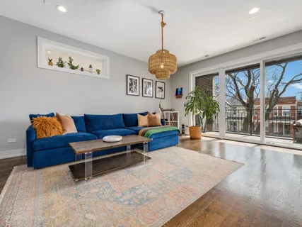 a living room with furniture a flat screen tv and a large window