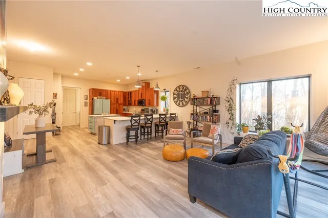 a bedroom with a bed and a large window with outer view