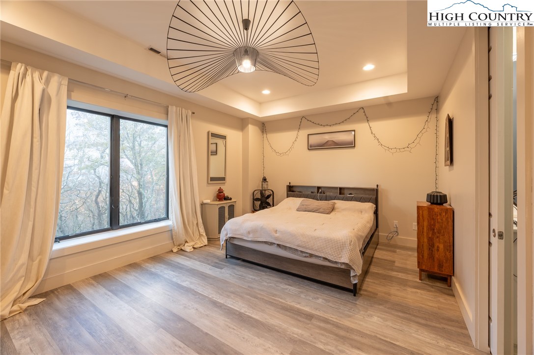 1390 Ransey Woodring Road Todd, NC 28684 - Photo 19 of 48 a bedroom with a bed and a large window with outer view