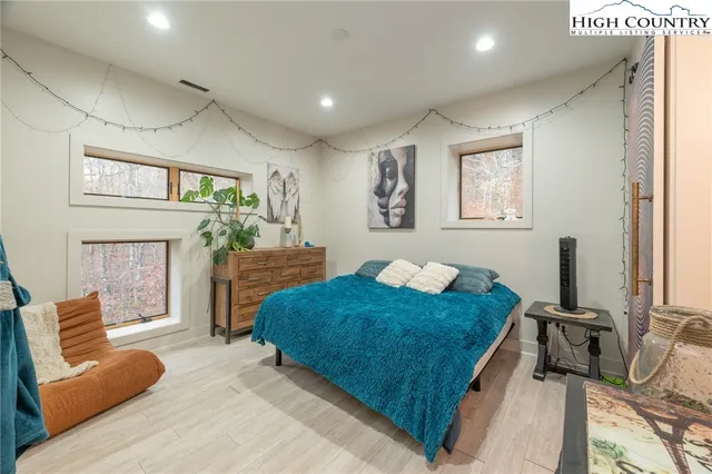 a view of a livingroom with wooden floor and stairs