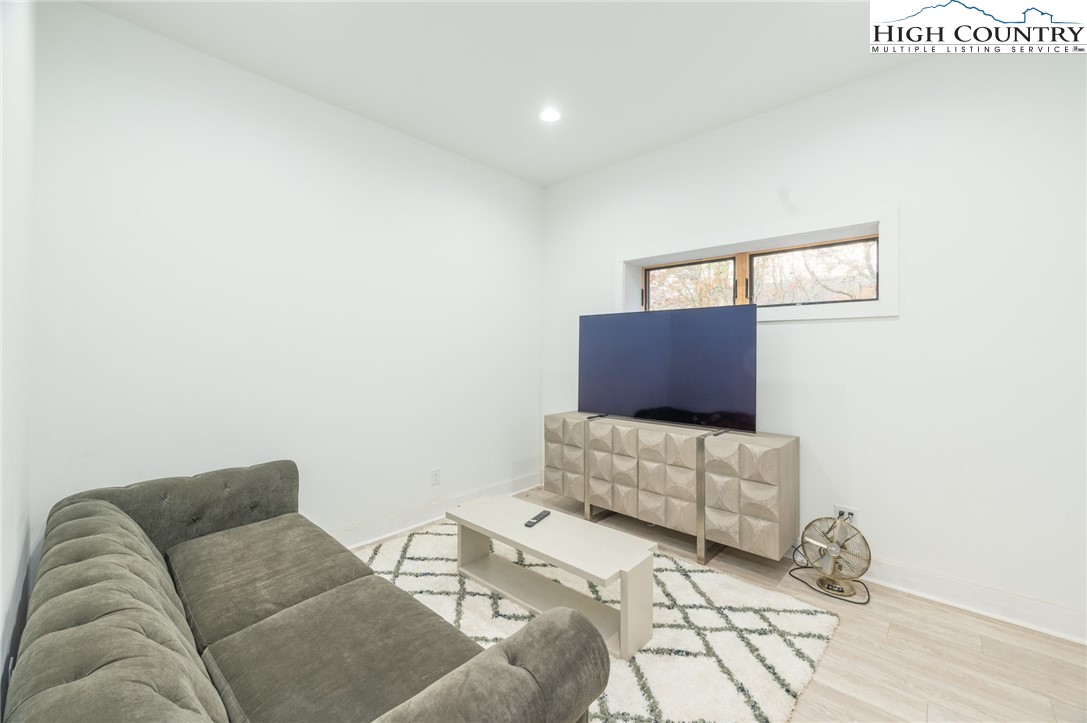 1390 Ransey Woodring Road Todd, NC 28684 - Photo 26 of 48 a living room with furniture and a couch