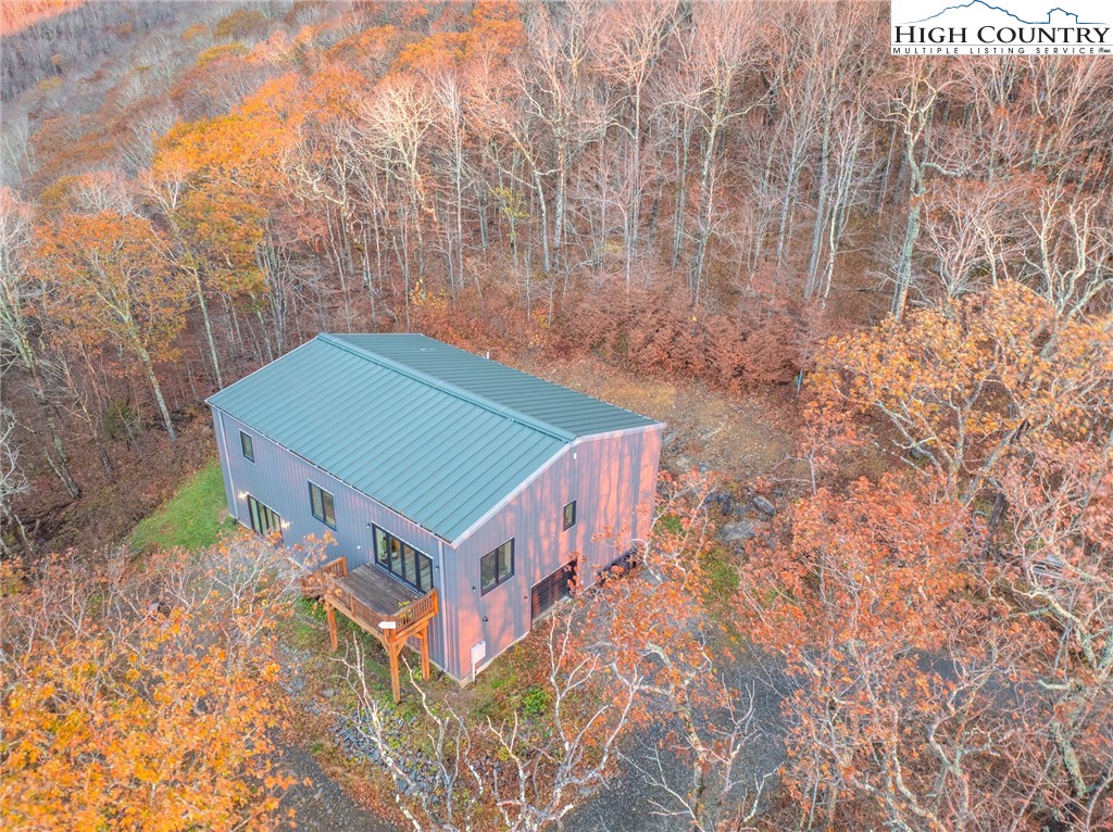 1390 Ransey Woodring Road Todd, NC 28684 - Photo 35 of 48 a backyard of a house with large trees
