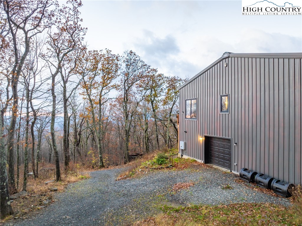 1390 Ransey Woodring Road Todd, NC 28684 - Photo 36 of 48 a view of a house with a yard