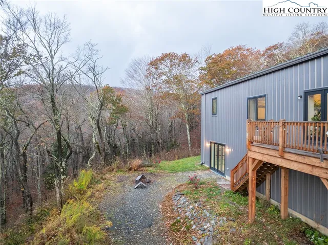 a view of a dry yard with wooden fence