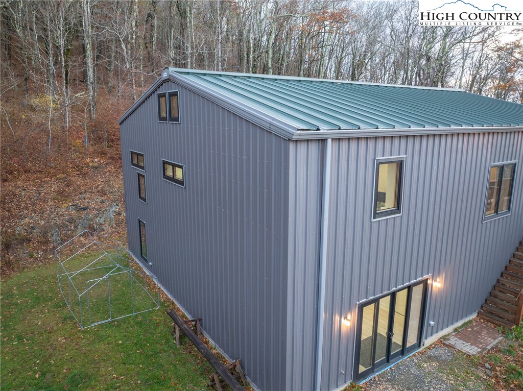 1390 Ransey Woodring Road Todd, NC 28684 - Photo 39 of 48 a view of a house with a yard