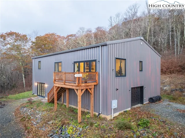 a large kitchen with stainless steel appliances granite countertop a stove a refrigerator and a kitchen island with wooden floor