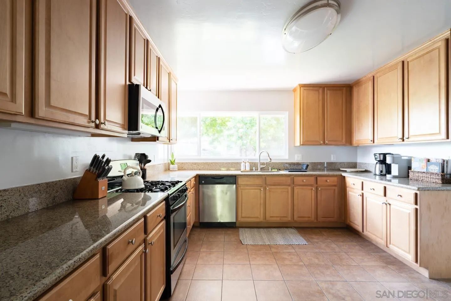 5238 La Jolla Boulevard San Diego, CA 92037 - Photo 15 of 46 a kitchen with a sink stove and cabinets