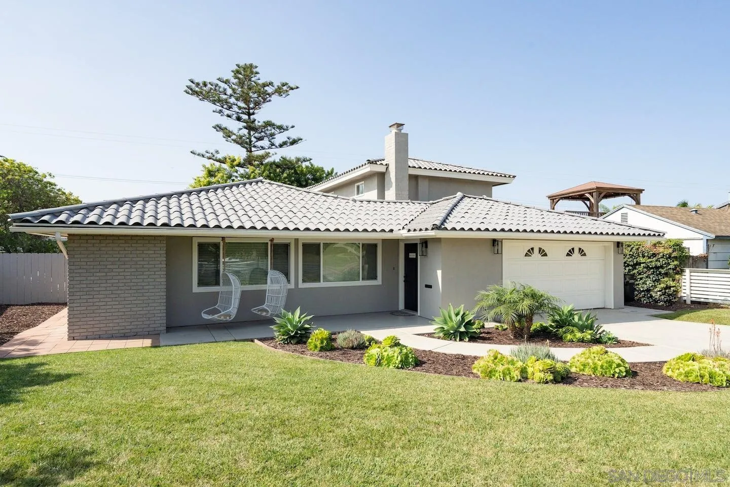 5238 La Jolla Boulevard San Diego, CA 92037 - Photo 2 of 46 a front view of a house with a yard and potted plants