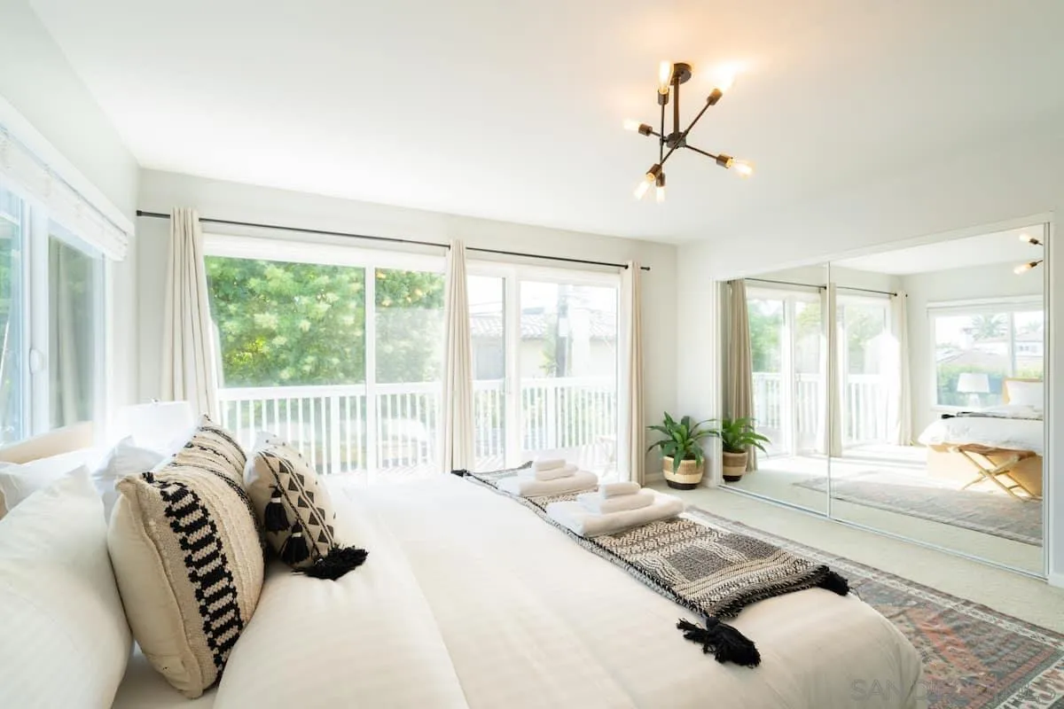 5238 La Jolla Boulevard San Diego, CA 92037 - Photo 32 of 46 a spacious bedroom with a bed and a large window