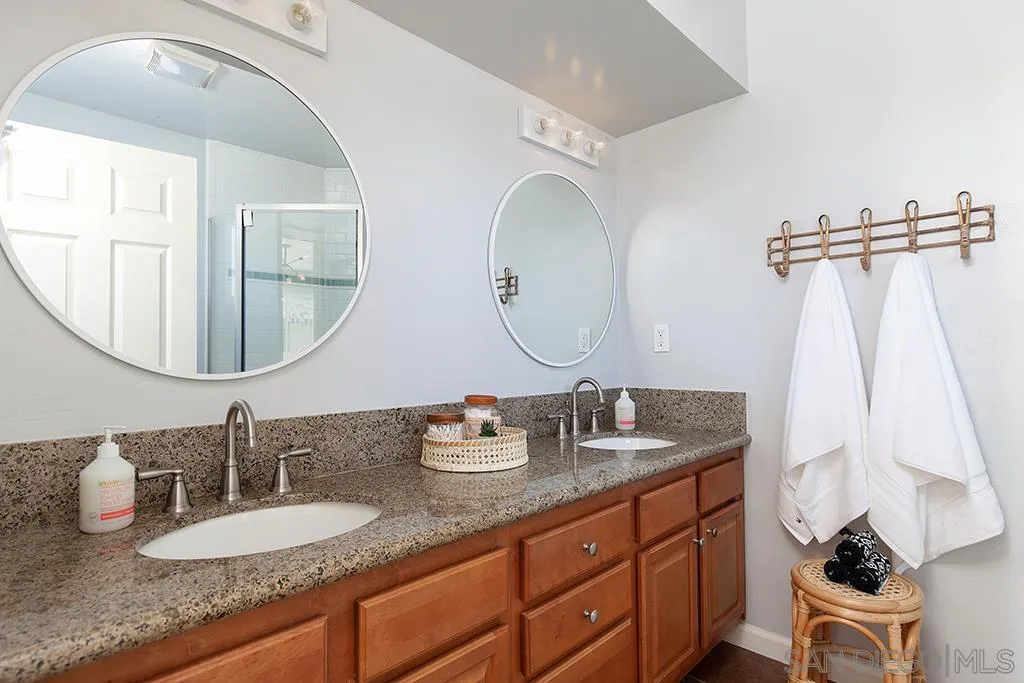 5238 La Jolla Boulevard San Diego, CA 92037 - Photo 35 of 46 a bathroom with a granite countertop double vanity sinks and a mirror