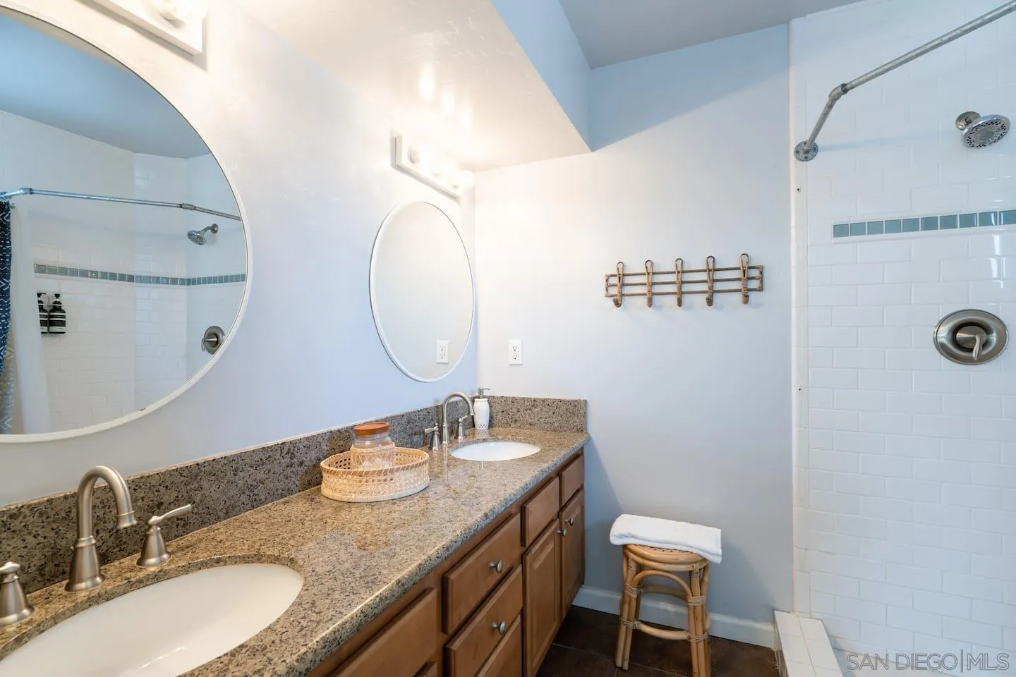 5238 La Jolla Boulevard San Diego, CA 92037 - Photo 36 of 46 a bathroom with a granite countertop sink and a mirror