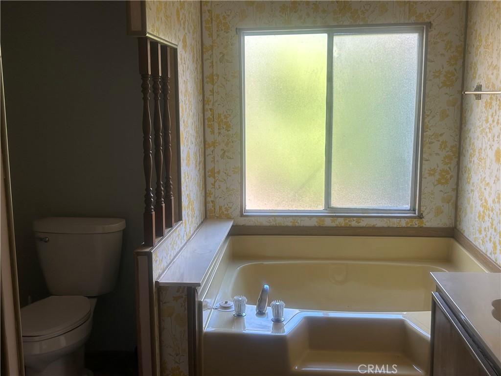 6773 Sayre Avenue Nice, CA 95464 - Photo 12 of 16 a bathroom with a bathtub and window