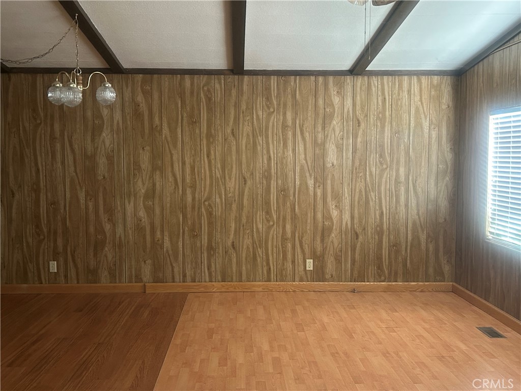 6773 Sayre Avenue Nice, CA 95464 - Photo 9 of 16 an empty room with wooden floor and windows