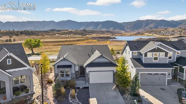 a view of houses with a lake and a mountain