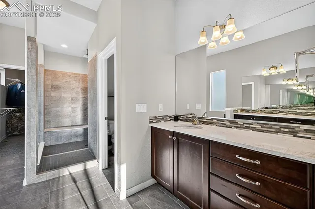 a view of a kitchen with a sink and refrigerator