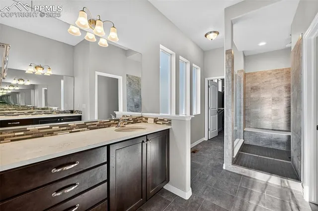 a large kitchen with a counter space a sink stainless steel appliances and cabinets