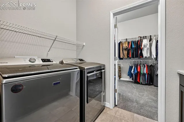a view of a storage and utility room with washer and dryer