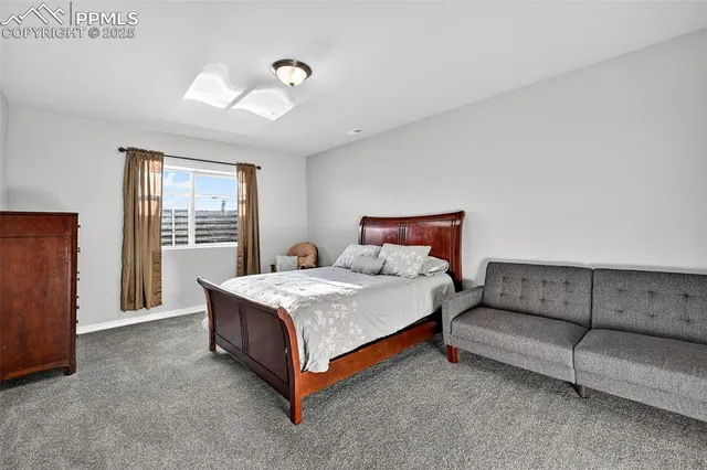 a bedroom with a bed rug and window