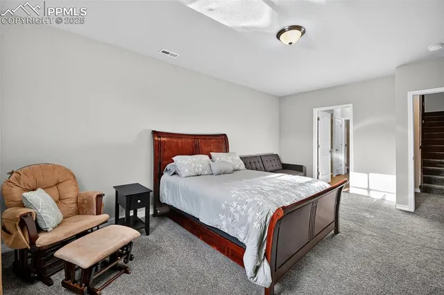 a bedroom with a bed and a chair