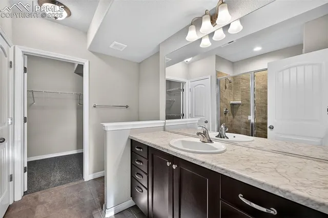 a bathroom with a sink double vanity and a mirror