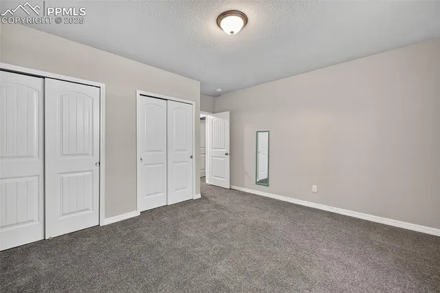 an empty room with closet area