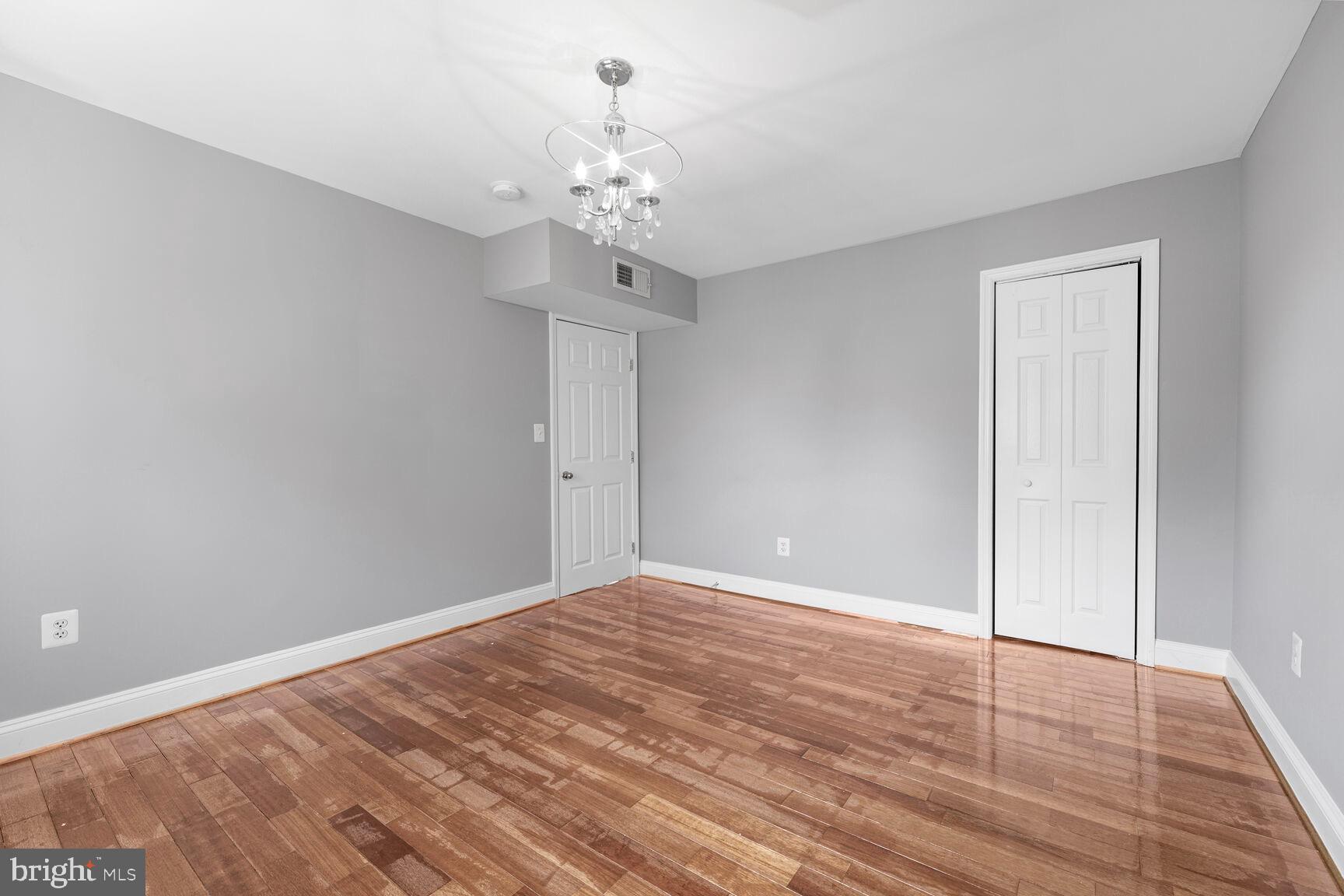 3876 9th Street Southeast, Unit 301 Washington, DC 20032 - Photo 11 of 16 a view of an empty room with wooden floor