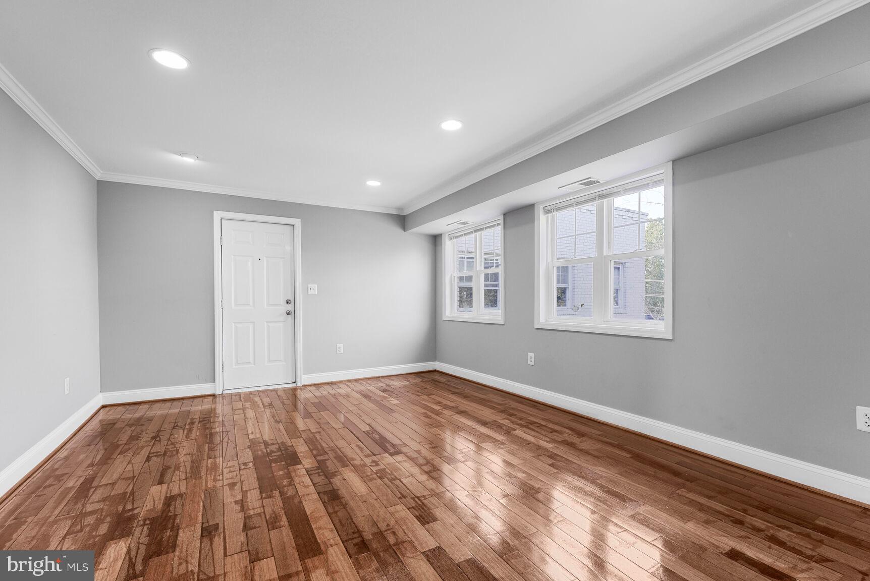 3876 9th Street Southeast, Unit 301 Washington, DC 20032 - Photo 4 of 16 a view of empty room with wooden floor and fan
