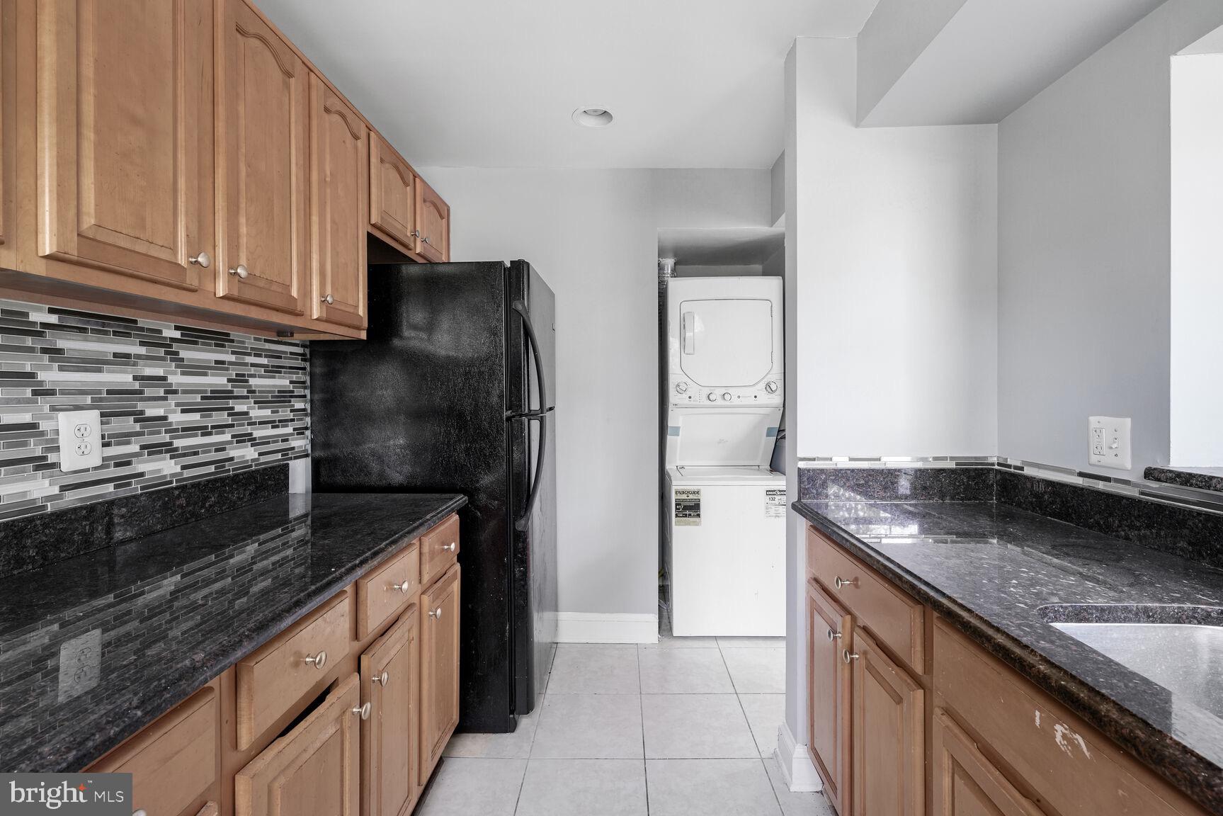 3876 9th Street Southeast, Unit 301 Washington, DC 20032 - Photo 9 of 16 a kitchen with a sink and a stove