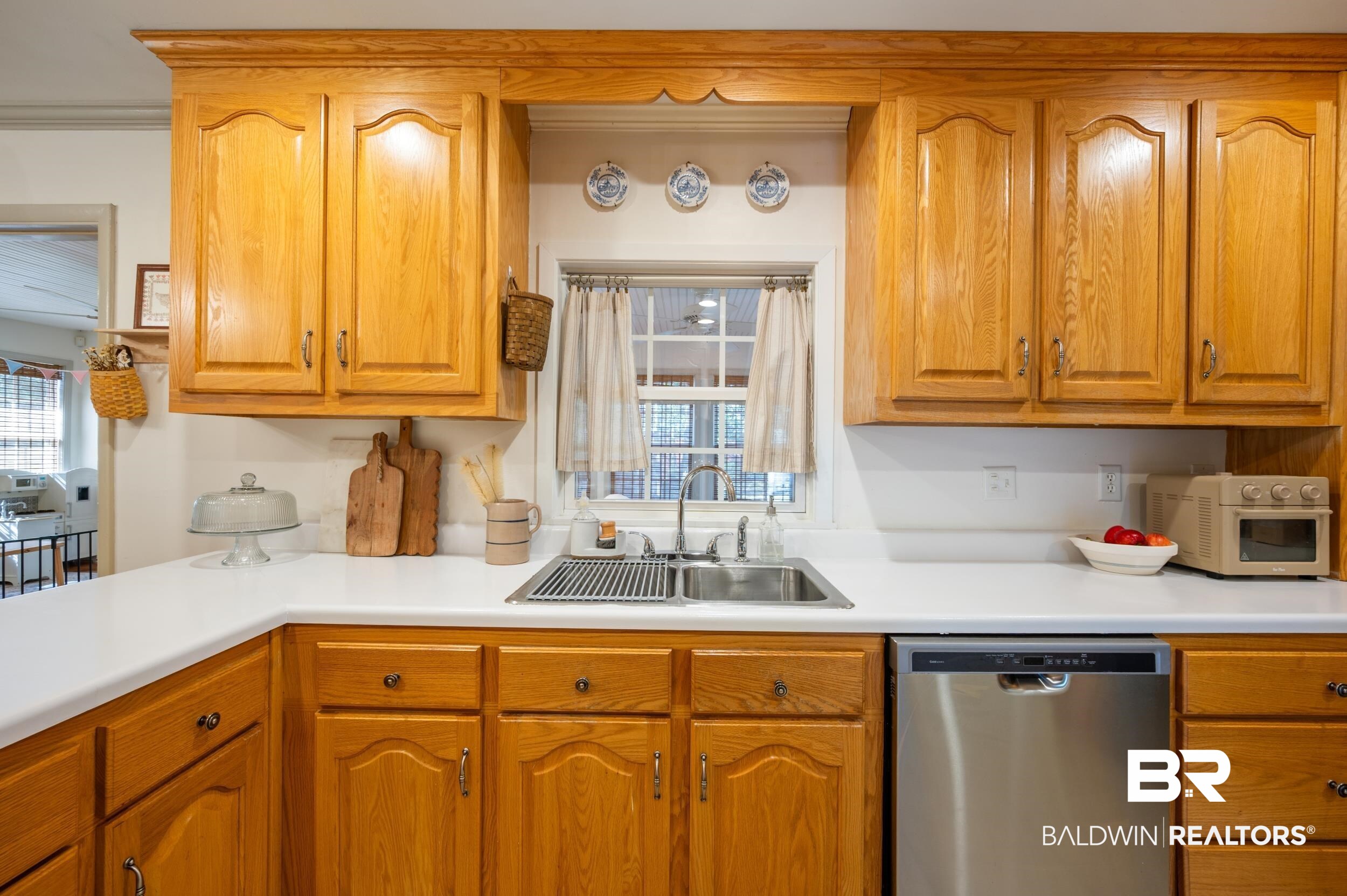 809 Moog Avenue Bay Minette, AL 36507 - Photo 13 of 33 Kitchen with dishwasher, light countertops, wood finish cabinets, and white microwave
