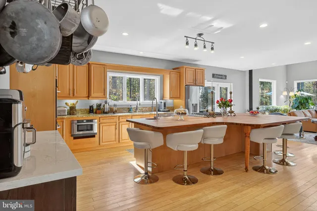 a kitchen with stainless steel appliances granite countertop a sink and a refrigerator
