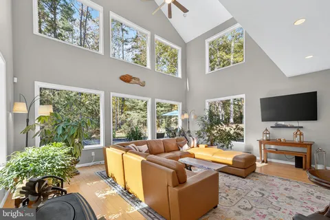 a living room with furniture and large windows