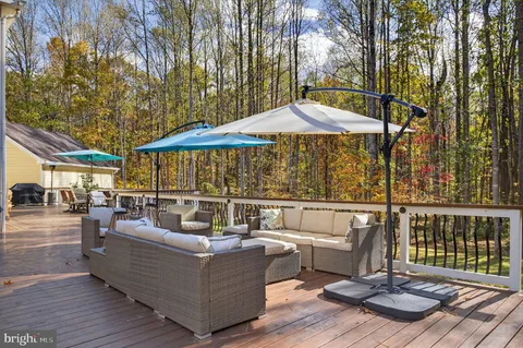 a view of a patio with a table and chairs under an umbrella